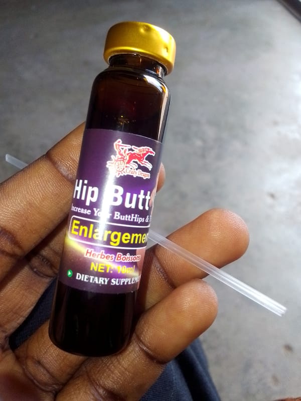Person holds novelty dietary supplement bottle with dragon logo
