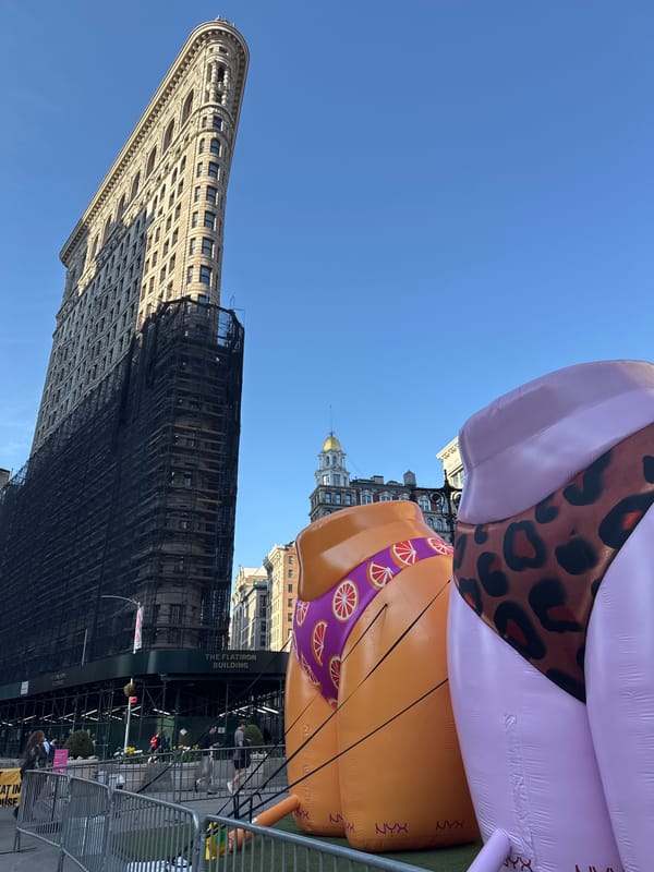 Flatiron Building under construction with inflatable displays nearby