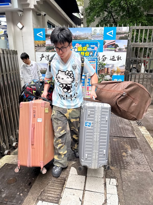 Traveler with luggage spotted on Yuzhong District sidewalk