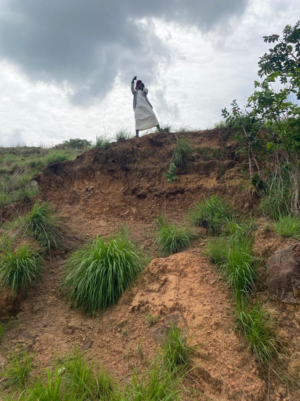 Person traverses steep hillsides in rural Nigeria countryside