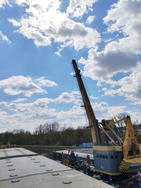Industrial barge with cranes navigates Moscow Canal near Yakhroma