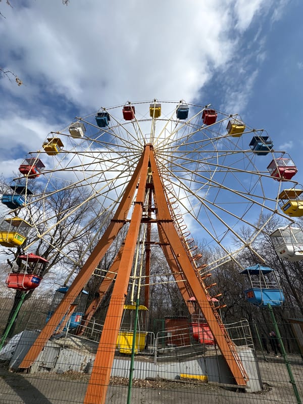 Colorful Ferris wheel operates under blue skies in Ulyanovsk