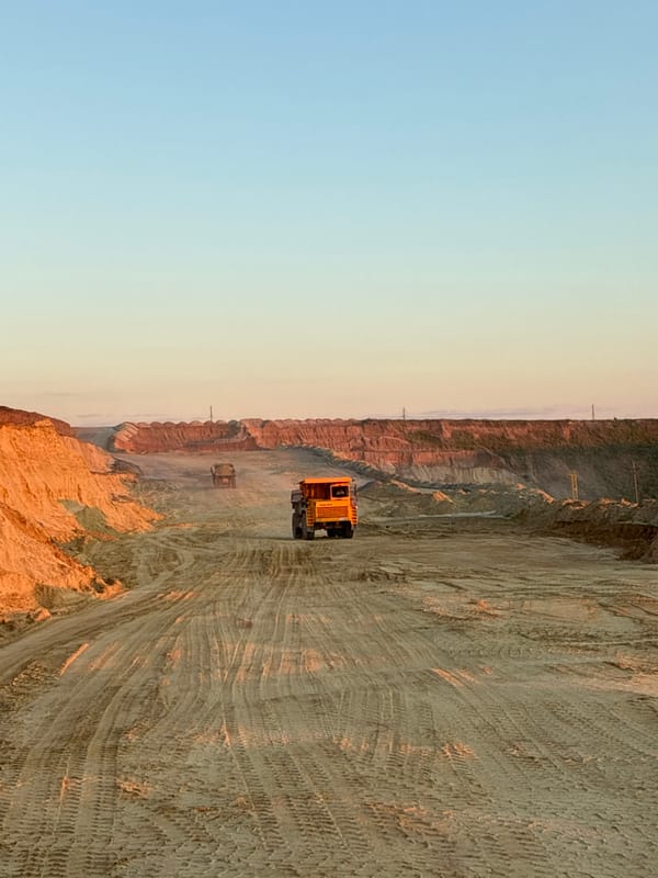 Excavator loads dump truck at Tatsinskaya quarry site