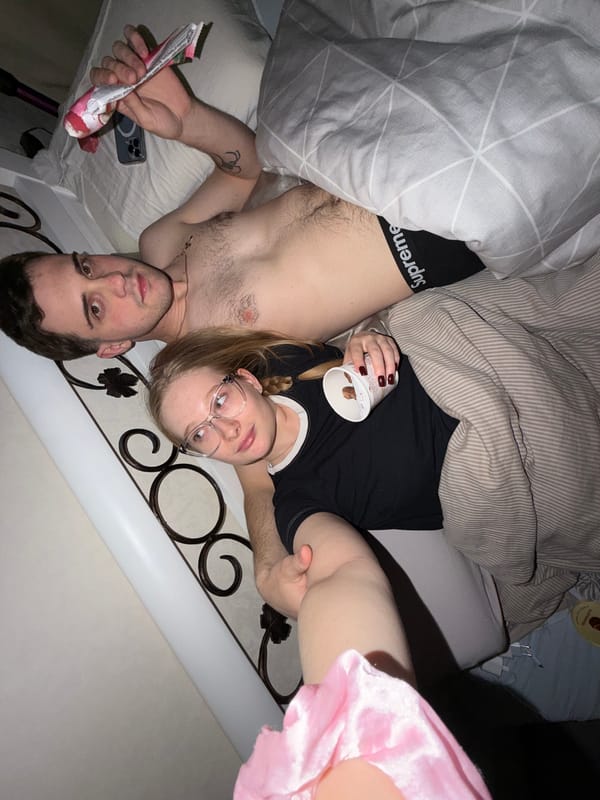Couple shares snacks in bedroom in Rossiyskiy, Russia