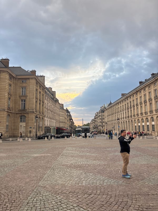 Tourist photographs Paris street scene with Eiffel Tower backdrop