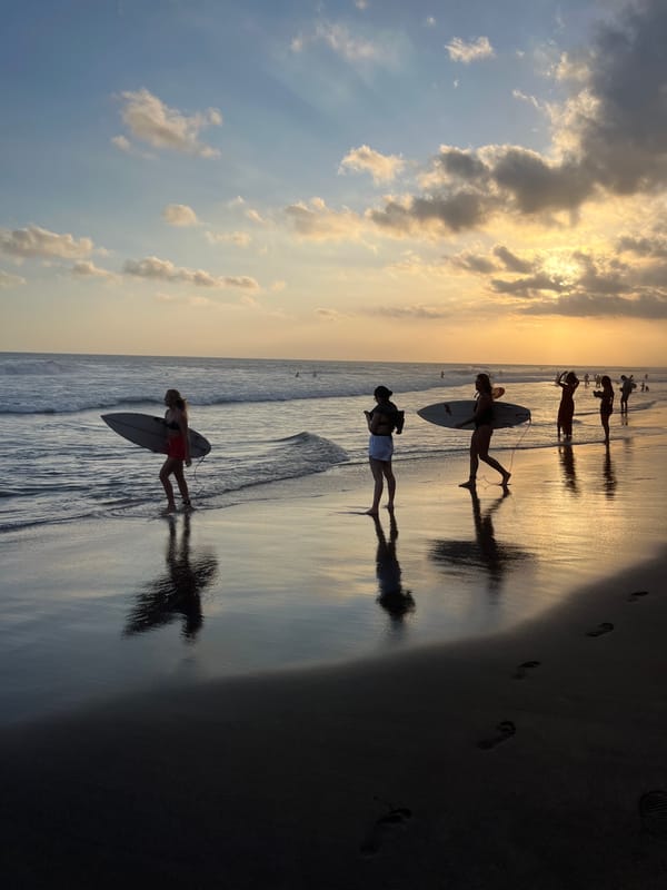 Sunset beach scenes with surfers and musician captured in Bali