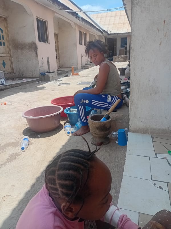 Family bathing activities documented in Lokoja residential courtyard