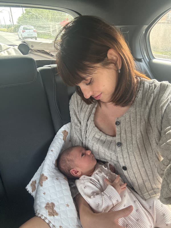 Mother holds newborn baby in car backseat, Nettuno Italy