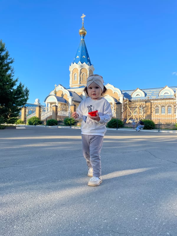 Family enjoys afternoon outing at Izhevsk park with playground visit