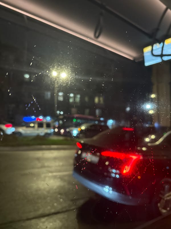 Rainy night street view captured through vehicle windows in Yerevan