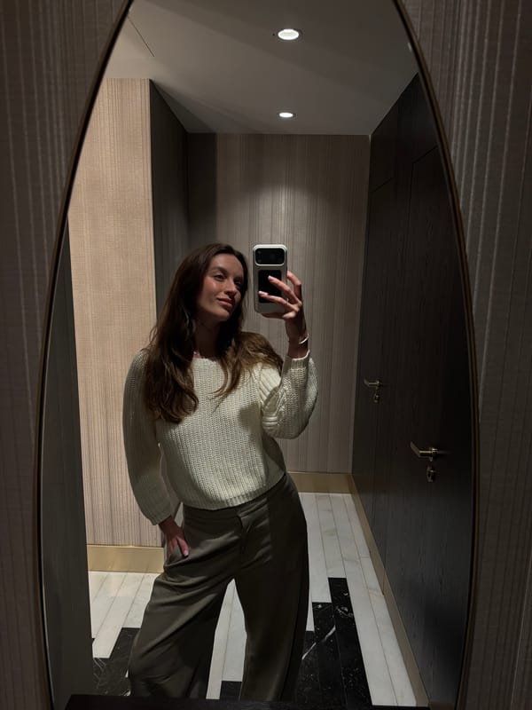 Woman takes mirror selfies in interior space, Budva