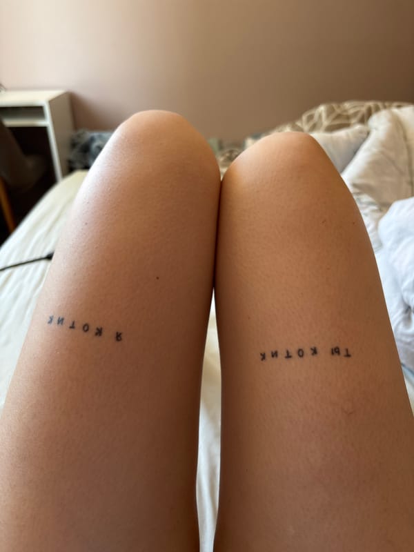 Person displays Cyrillic leg tattoos in Tbilisi