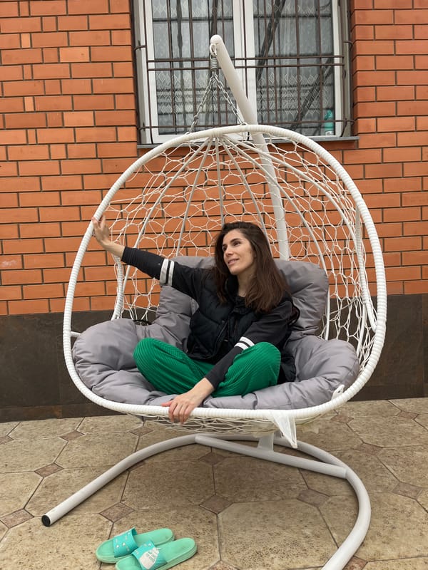 Mother and child enjoy swing time in Kaspiysk courtyard