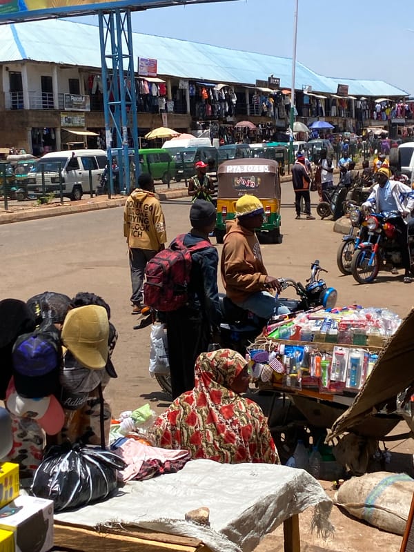 Morning marketplace bustles with vendors, motorcycles in Bukuru, Nigeria