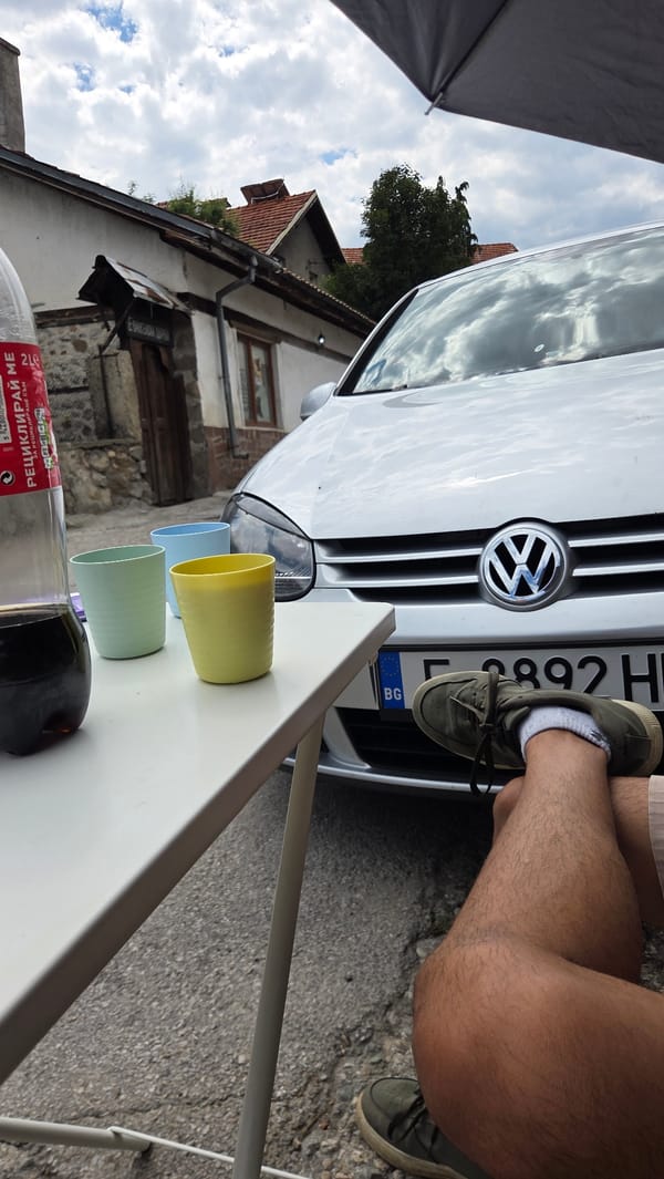 Multiple Volkswagens parked on a quiet Bania street, mid-activity