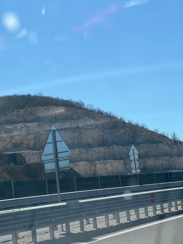 Road signs mounted on cliff face in Peshterna, Bulgaria