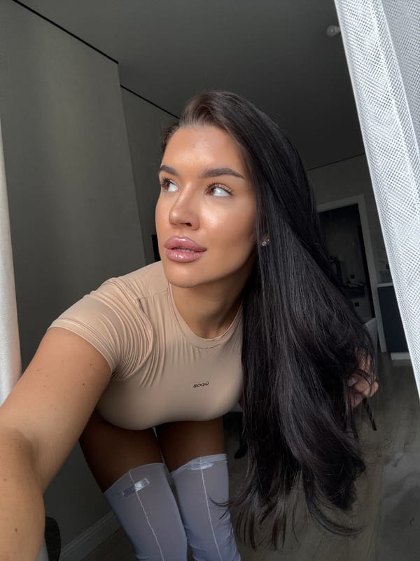 Woman in beige outfit observed indoors in Kazan