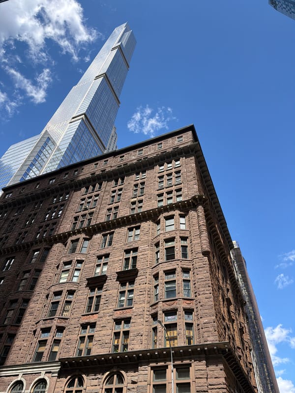 Street photographer captures Manhattan buildings on sunny afternoon