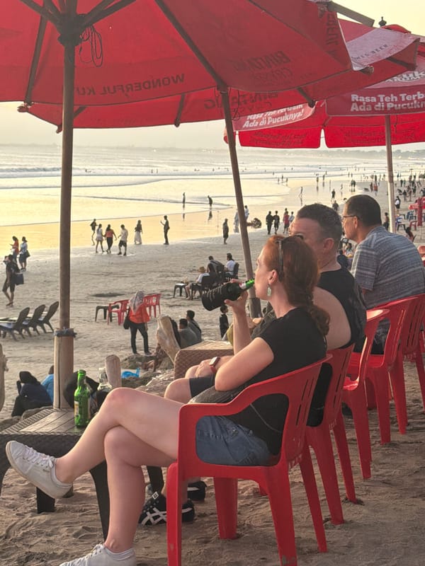 Sunset hour on Kuta Beach, streets and shoreline both busy
