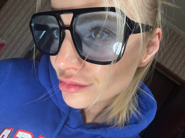 Blonde woman in glasses photographed multiple times in Saint Petersburg