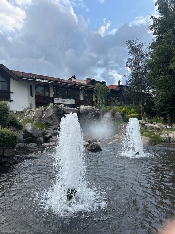 Bansko old town: fountains, stone houses, and a piano planter