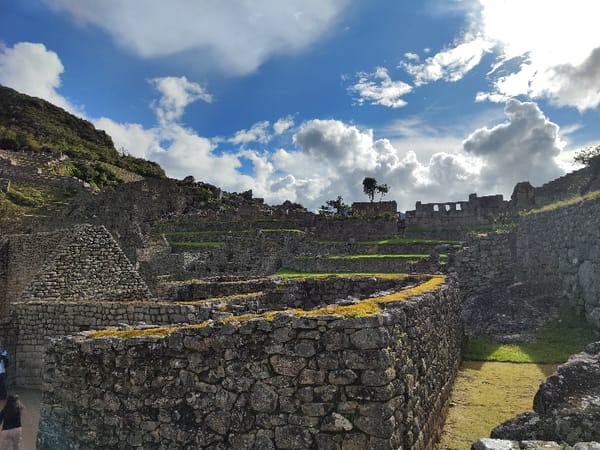 Tourists explore Machu Picchu ruins during evening hours