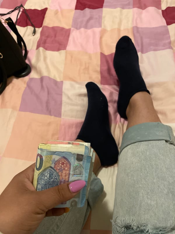 Person holds Euro cash on bed in Dronten
