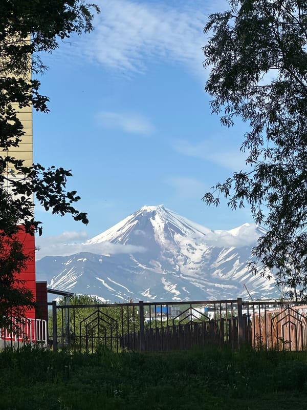Kamchatka's iconic volcanoes tower over Petropavlovsk on a clear summer day