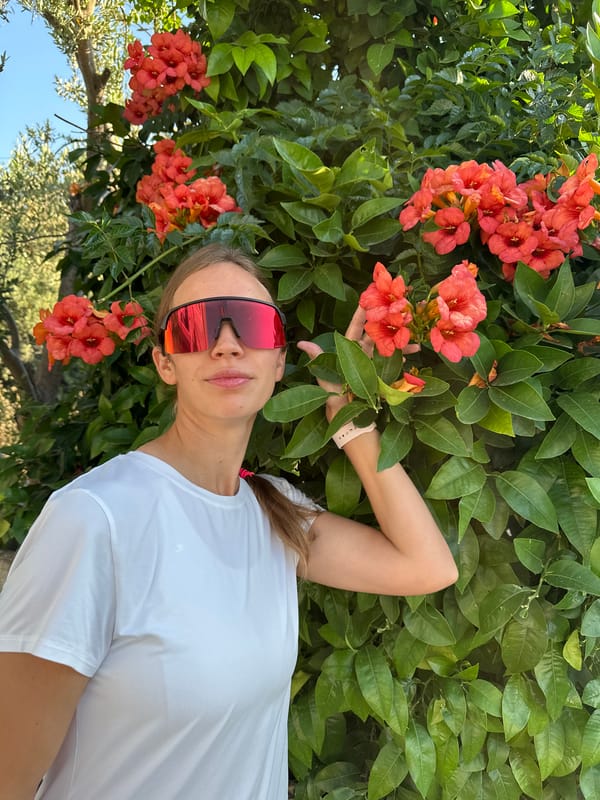 Woman waves under bougainvillea tree in Fethiye, Turkey