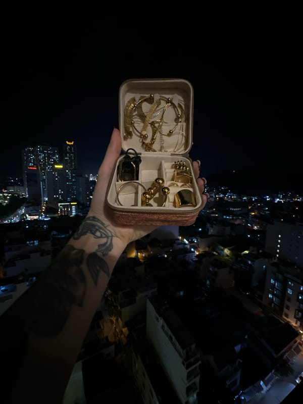 Gold jewelry box shown off against Nha Trang's night skyline