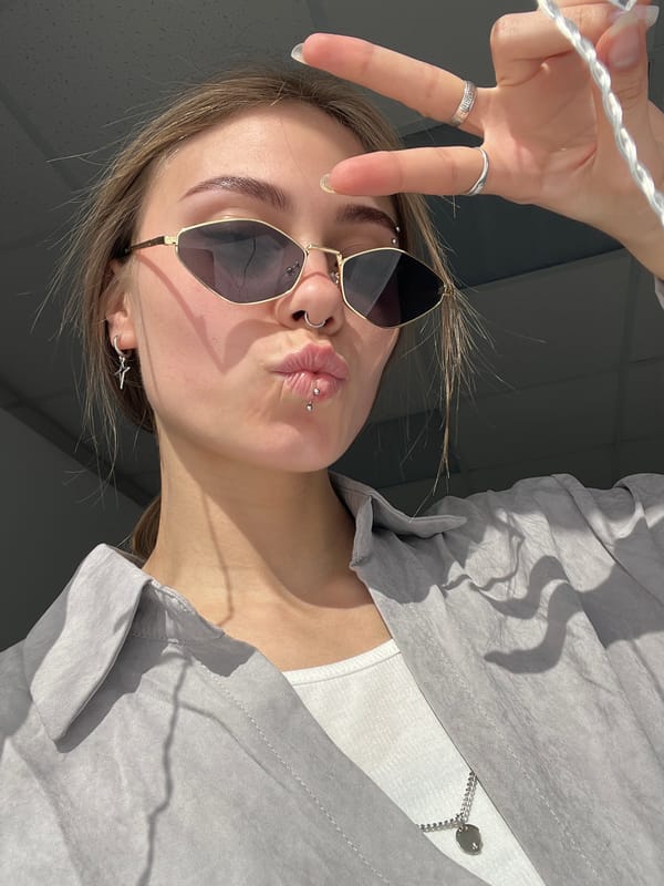 Young women photograph themselves during morning selfie session