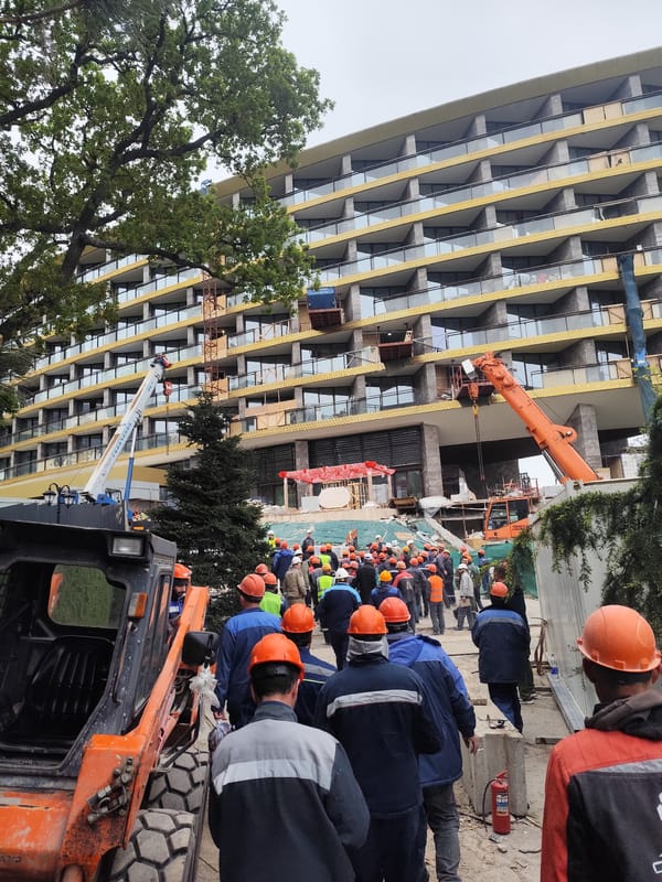 Construction crew active at Simeiz building site with heavy equipment