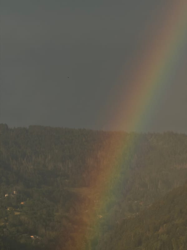 Rainbow over Cluses mountains on a stormy June evening