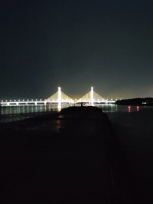 Nighttime views of an illuminated suspension bridge over water