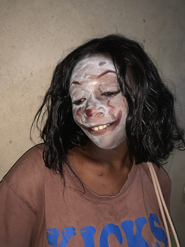 Person in theatrical makeup spotted on concrete in Agban