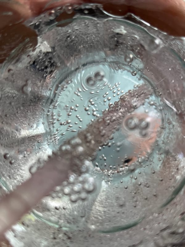 Person drinks sparkling water in Dhaka