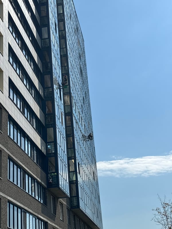 Window washers clean tall building in Vsevolozhsk, Russia
