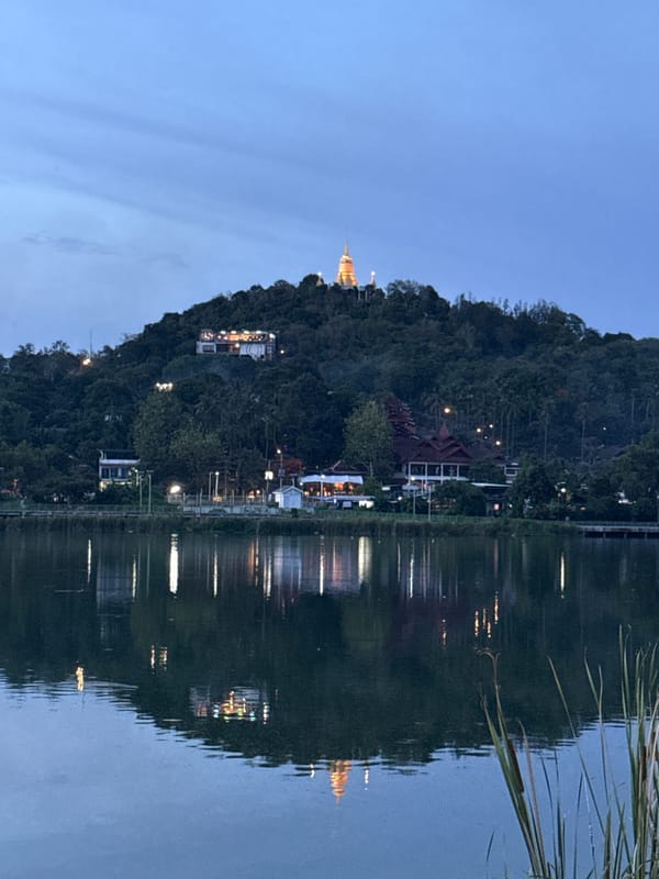 Hilltop stupa and lit-up bar at dusk, Baan Chaweng