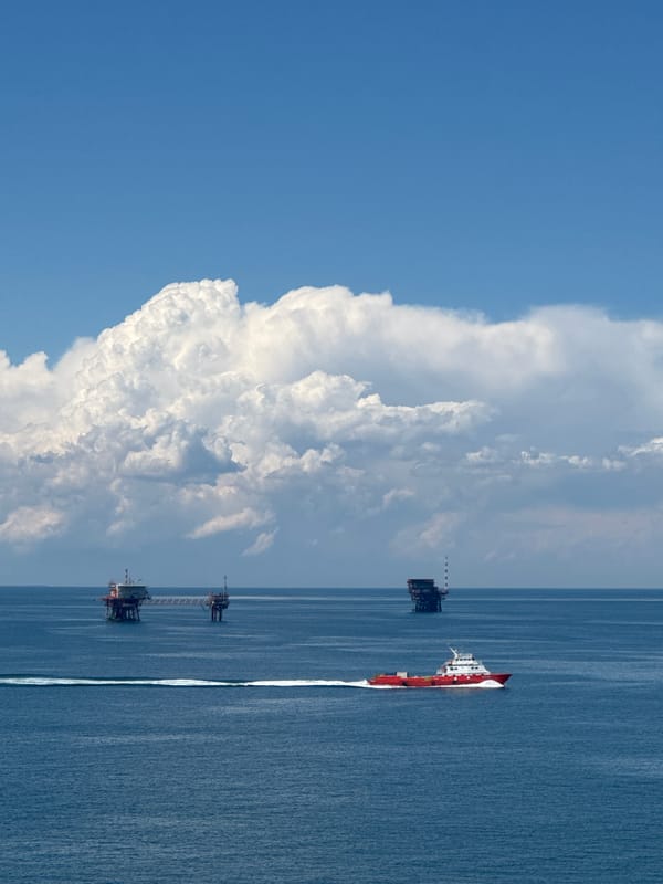Supply vessel transits Italian offshore oil platforms during afternoon