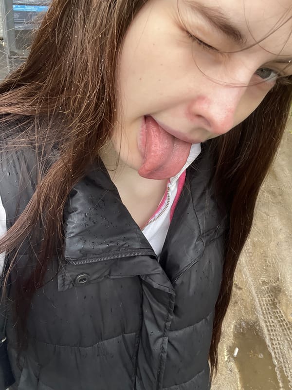 Woman takes playful selfies during rainy afternoon in Saint Petersburg