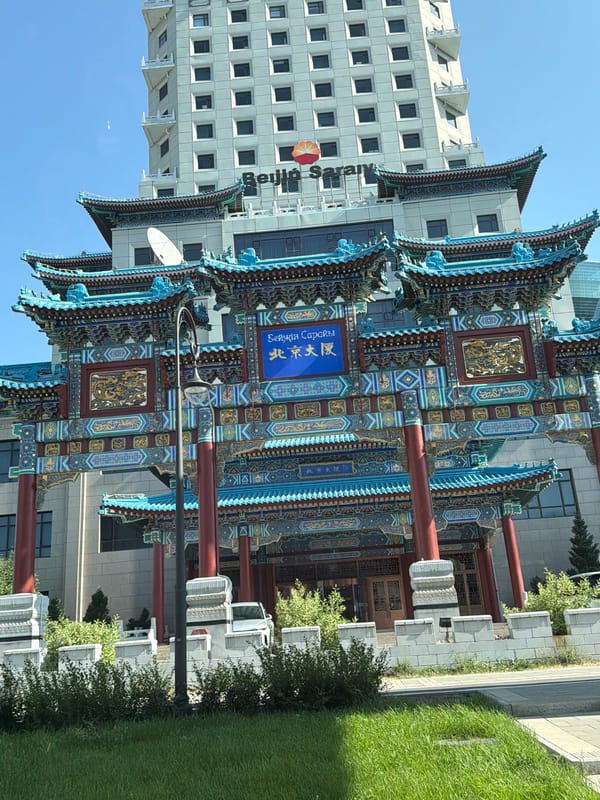 Traditional Chinese-style gate meets modern high-rise in Astana