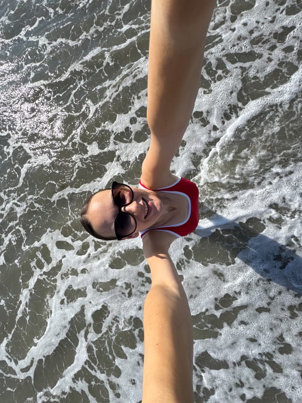 Selfies and shoreline shots at a Sochi pebble beach