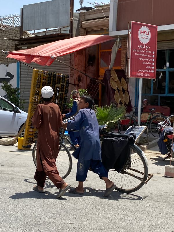 Everyday street life in Kandahar, vendors and pedestrians mid-morning