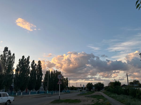 Golden hour light over Qobda streets and open sky