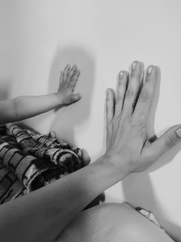 Adult and child share quiet moments in black and white