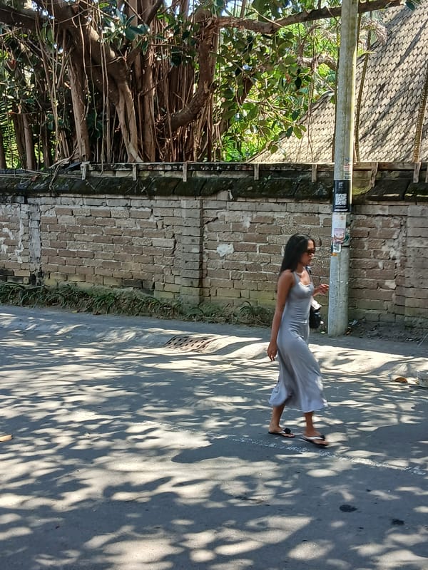 Foot traffic and scooters along Mengwi's temple-side streets