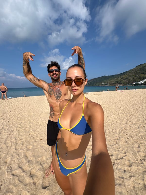 Couple takes beach selfies at Rawai Thailand early morning