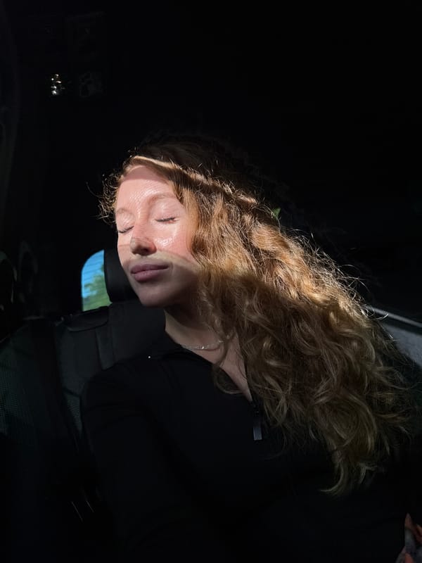 Woman rests in vehicle back seat in Kialasur, Abkhazia