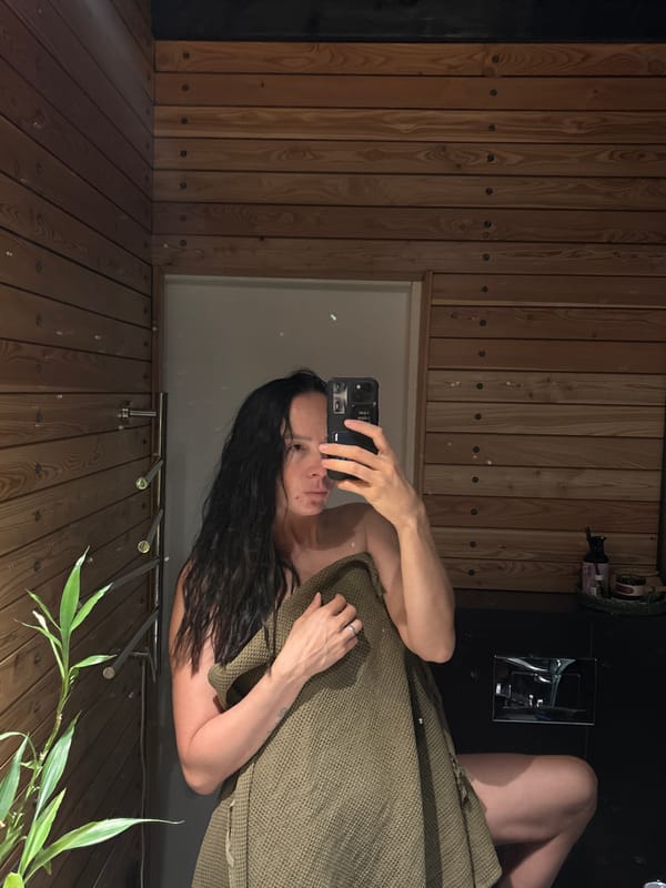 Woman takes towel selfie in Russian sauna facility