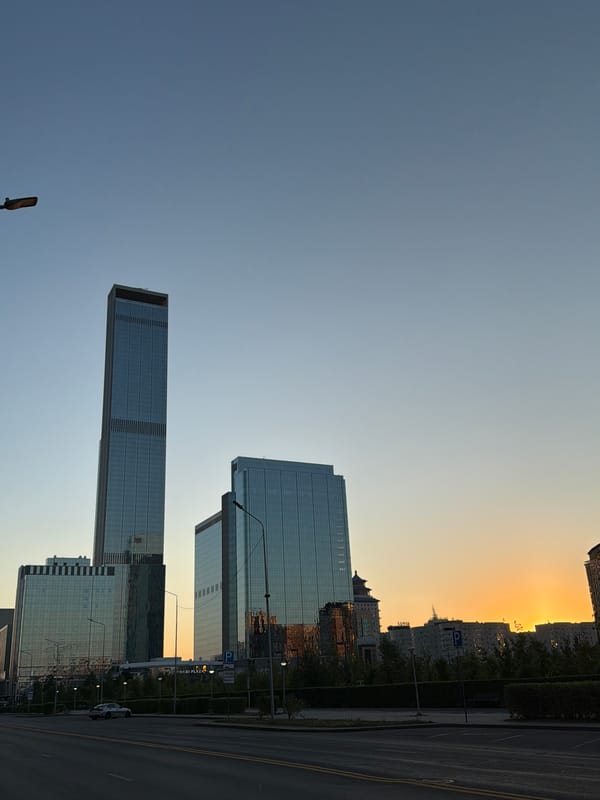Astana skyline at golden hour, modern towers and city streets